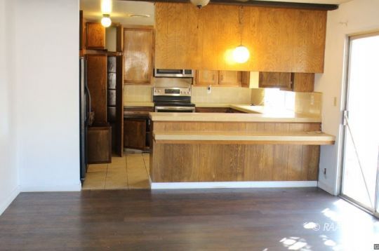 240 South Forest Knoll Street Ridgecrest, CA 93555 - Photo 5 of 23 a kitchen with stainless steel appliances a refrigerator and a stove