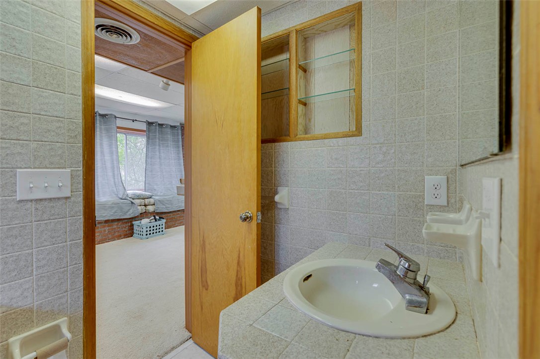 200 Valley View Drive Clemson, SC 29631 - Photo 24 of 31 This bright bathroom features tiled countertops and walls, offering functional design and a clean aesthetic.