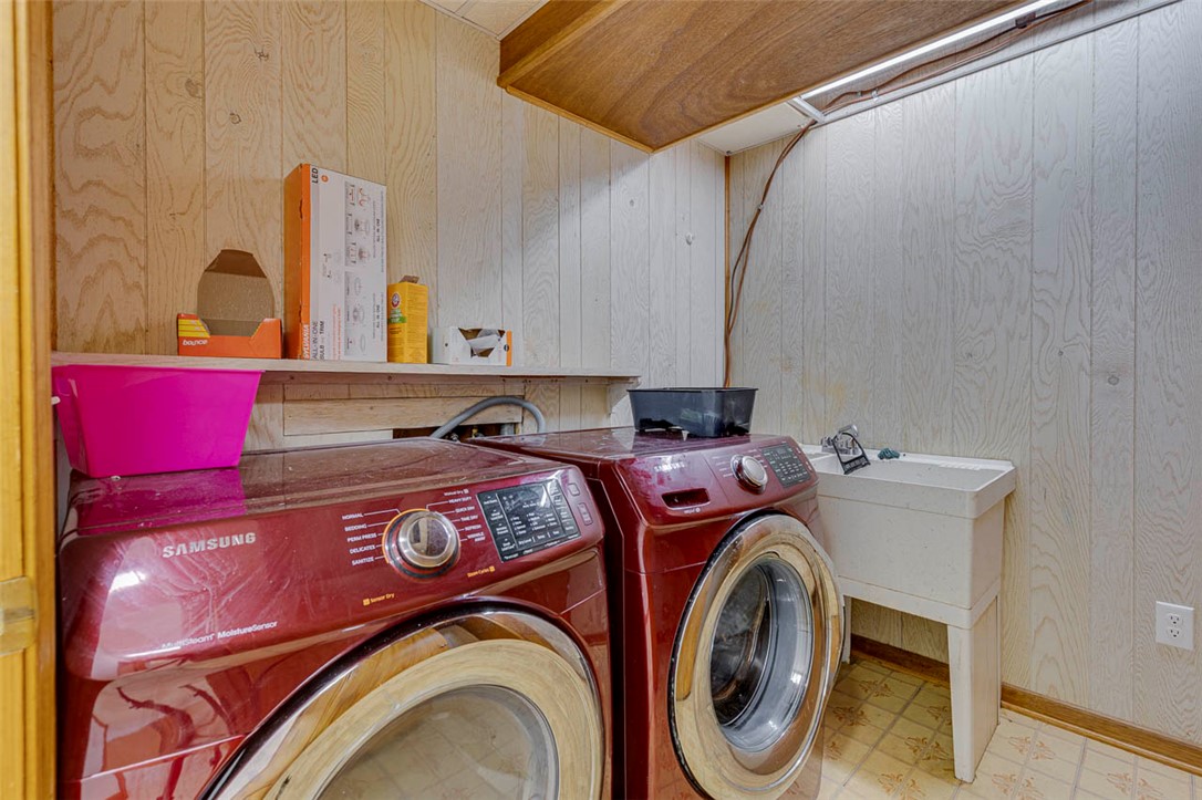 200 Valley View Drive Clemson, SC 29631 - Photo 27 of 31 This functional laundry area features modern appliances and a utility sink, perfect for daily chores.