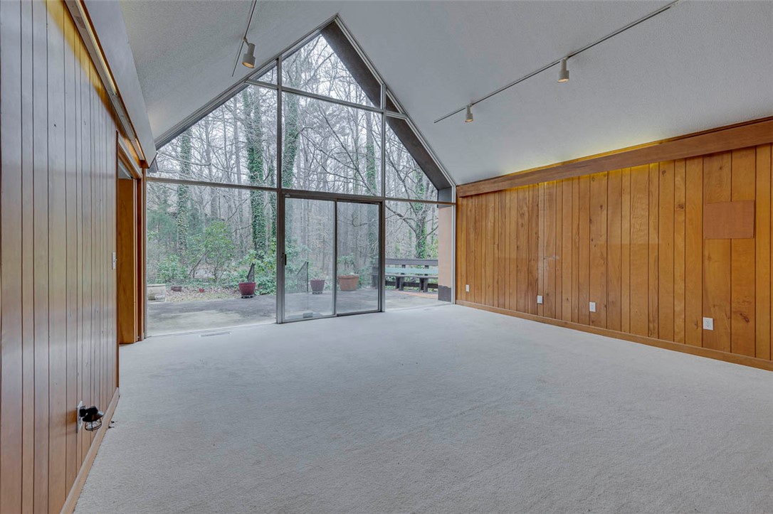 200 Valley View Drive Clemson, SC 29631 - Photo 4 of 31 This airy room features a soaring ceiling and a captivating woodland view.
