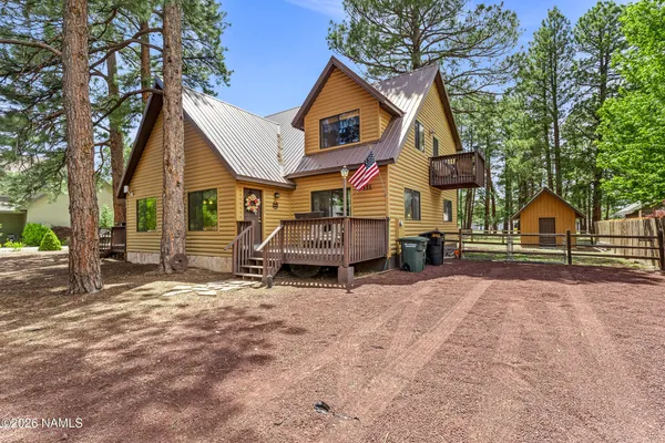 a view of house with a yard