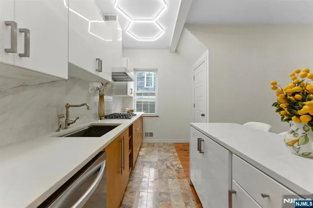 a kitchen with a sink a stove and cabinets