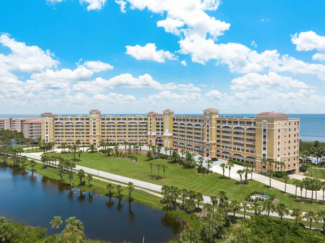 a view of a city with lots of residential buildings lake and ocean view