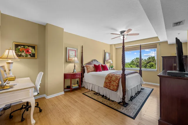 a bed room with a bed window and a chair