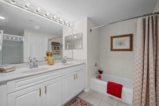 a bathroom with a sink vanity tub and shower