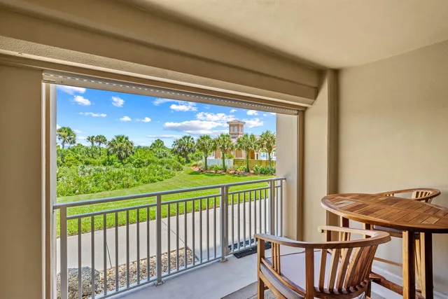a view of a chair and table in the balcony