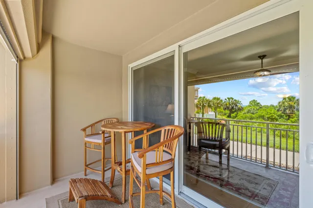 a view of a chairs and table in the balcony