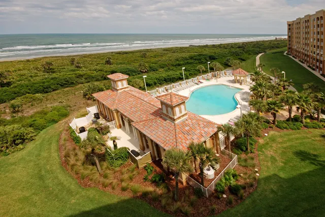 a dining room with furniture a rug and a large window
