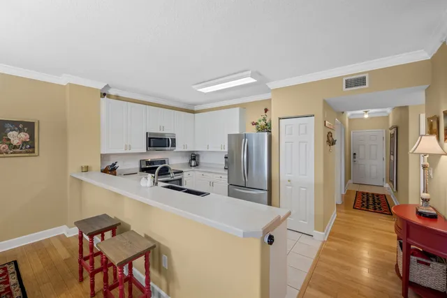 a kitchen with stainless steel appliances a refrigerator and a stove top oven
