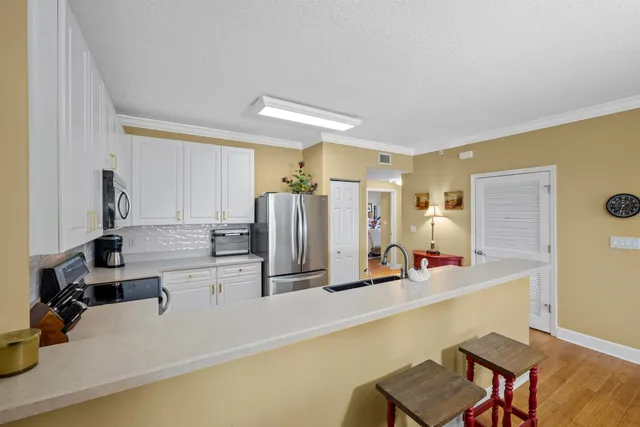 a kitchen with stainless steel appliances a sink and a refrigerator