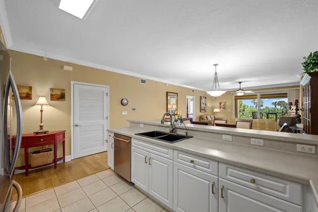 a kitchen with sink refrigerator and stove