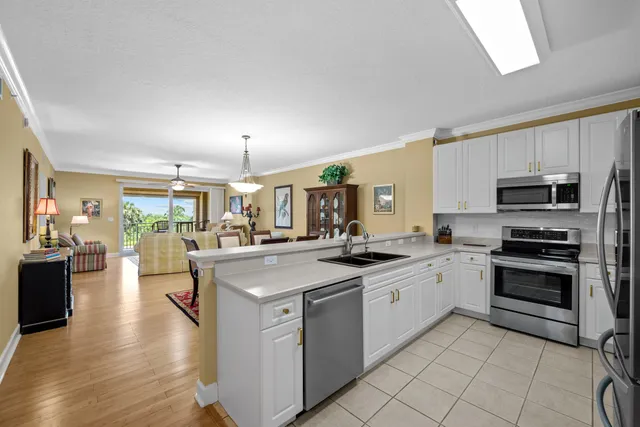a kitchen with stainless steel appliances granite countertop a stove oven and a refrigerator
