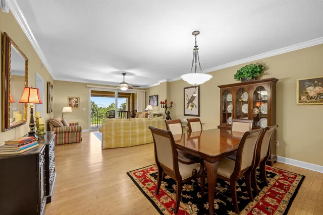 a dining room with furniture a chandelier and wooden floor