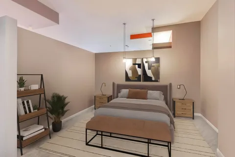 a bed room with a bed tv and a potted plant