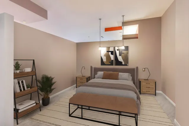 a bed room with a bed tv and a potted plant