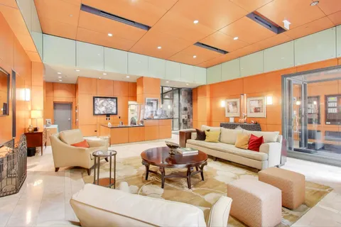 a view of a hall with a large kitchen area