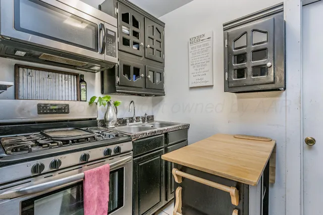 a kitchen with a stove and a microwave