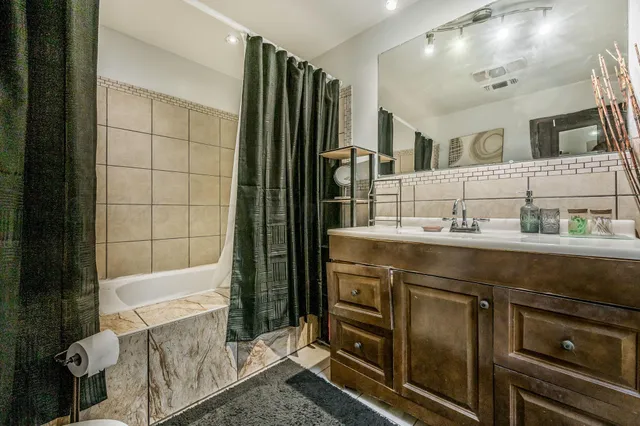 a bathroom with a sink a double vanity and a mirror