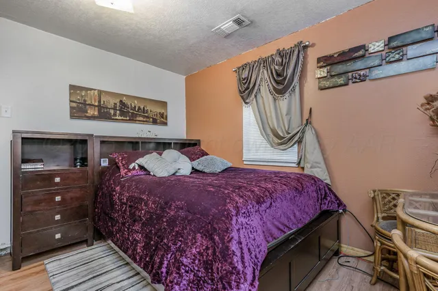 a bedroom with a bed and cabinets