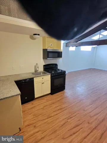 a kitchen with a refrigerator and cabinets