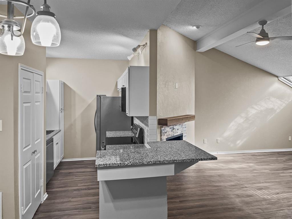 9600 Royal Lane, Unit 112 Dallas, TX 75243 - Photo 5 of 19 a kitchen with stainless steel appliances granite countertop a sink and a refrigerator