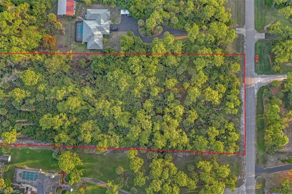 1970 17th Street Southwest Naples, FL 34117 - Photo 4 of 17 an aerial view of residential house with outdoor space and trees all around