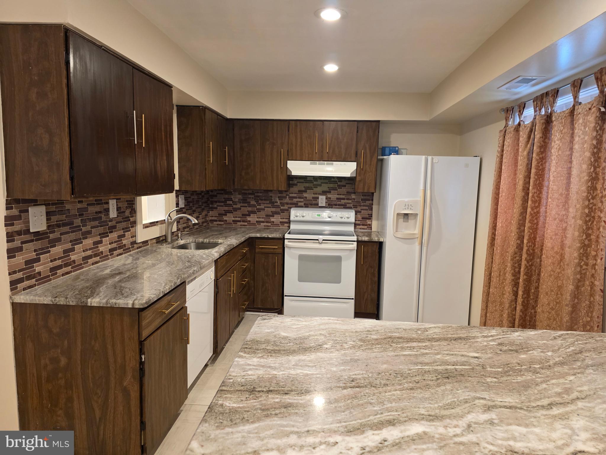 9 Georgetown Road Lindenwold, NJ 08021 - Photo 4 of 14 a kitchen with stainless steel appliances granite countertop a stove a refrigerator and a sink