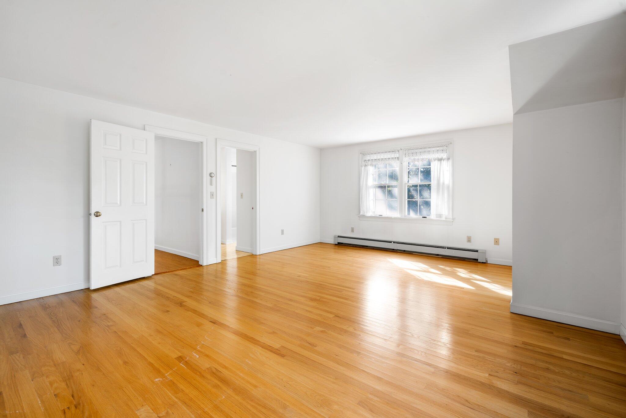 7 Abbey Gate Road Cotuit, MA 02635 - Photo 20 of 41 a view of empty room with wooden floor and fan