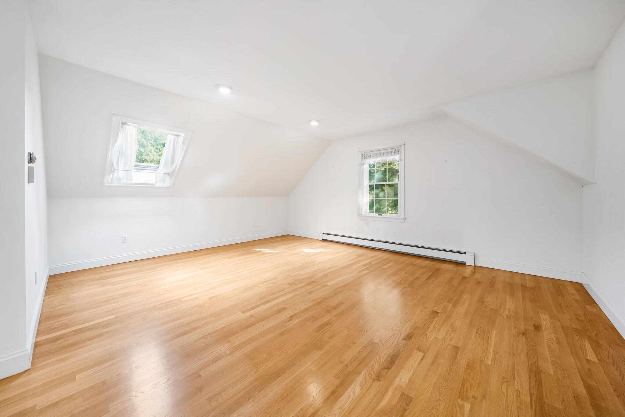 7 Abbey Gate Road Cotuit, MA 02635 - Photo 23 of 41 an empty room with wooden floor and windows
