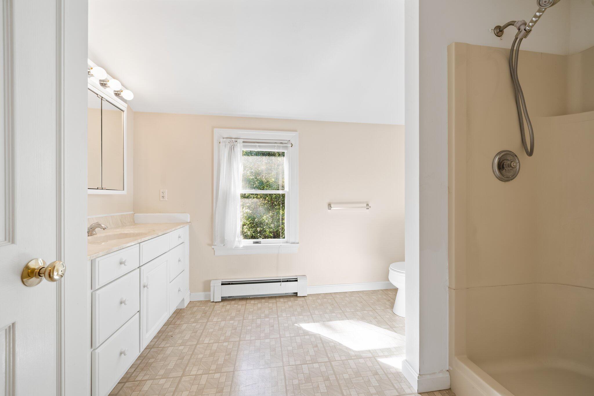 7 Abbey Gate Road Cotuit, MA 02635 - Photo 25 of 41 a bathroom with a granite countertop sink a toilet and shower