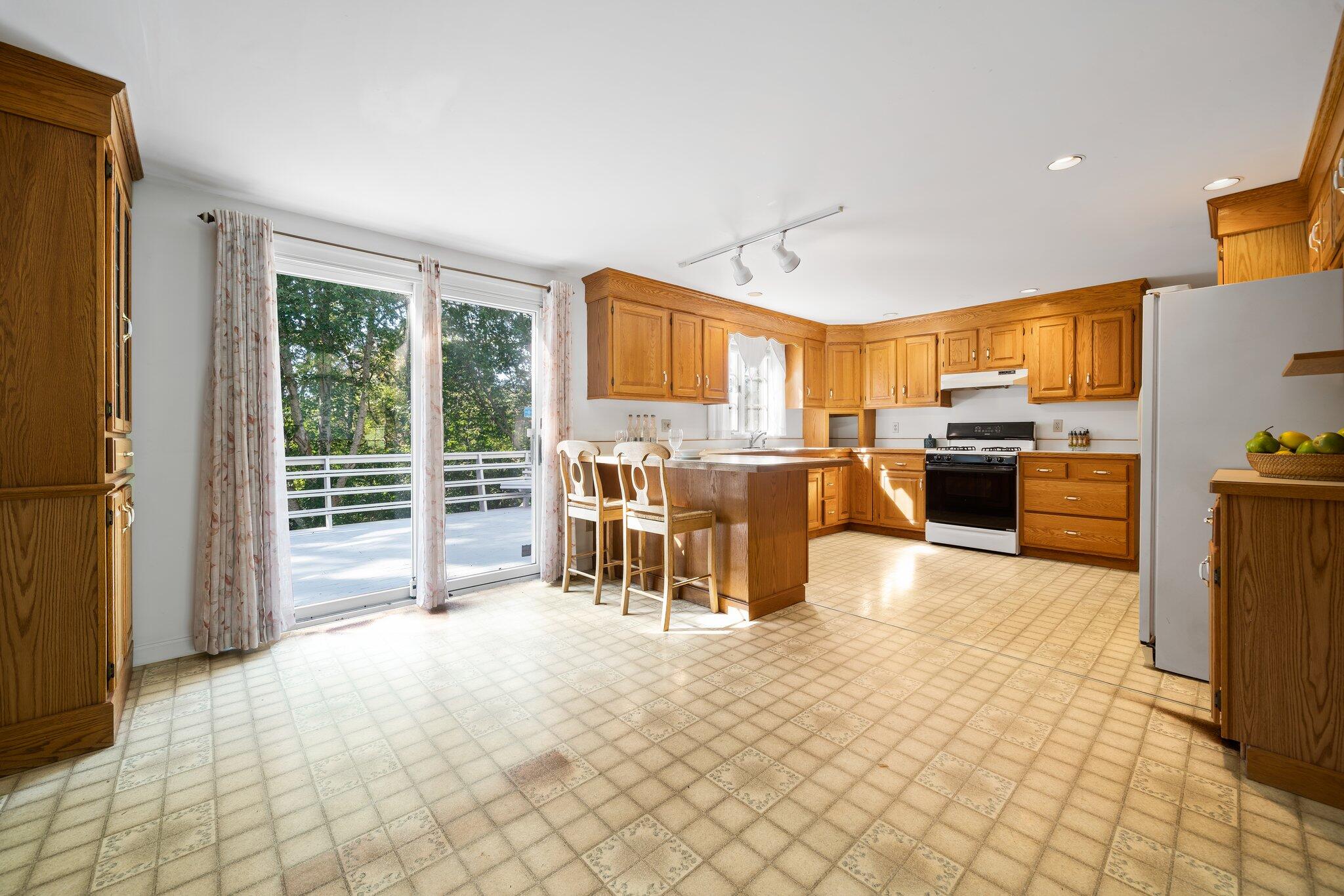 7 Abbey Gate Road Cotuit, MA 02635 - Photo 7 of 41 a living room with furniture a flat tv screen and next to a window
