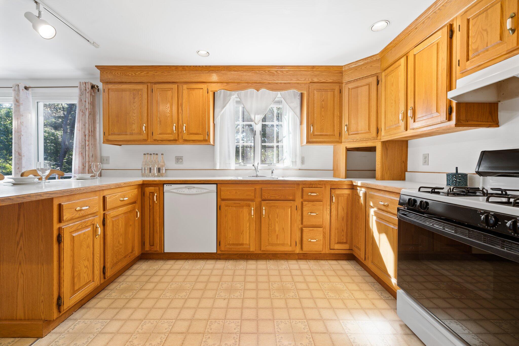 7 Abbey Gate Road Cotuit, MA 02635 - Photo 9 of 41 a kitchen with stainless steel appliances granite countertop a stove a sink and a microwave