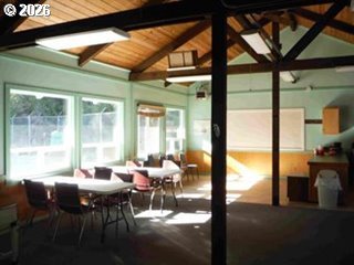 39 Easy Street Florence, OR 97439 - Photo 13 of 24 a dining room with furniture water view and large windows