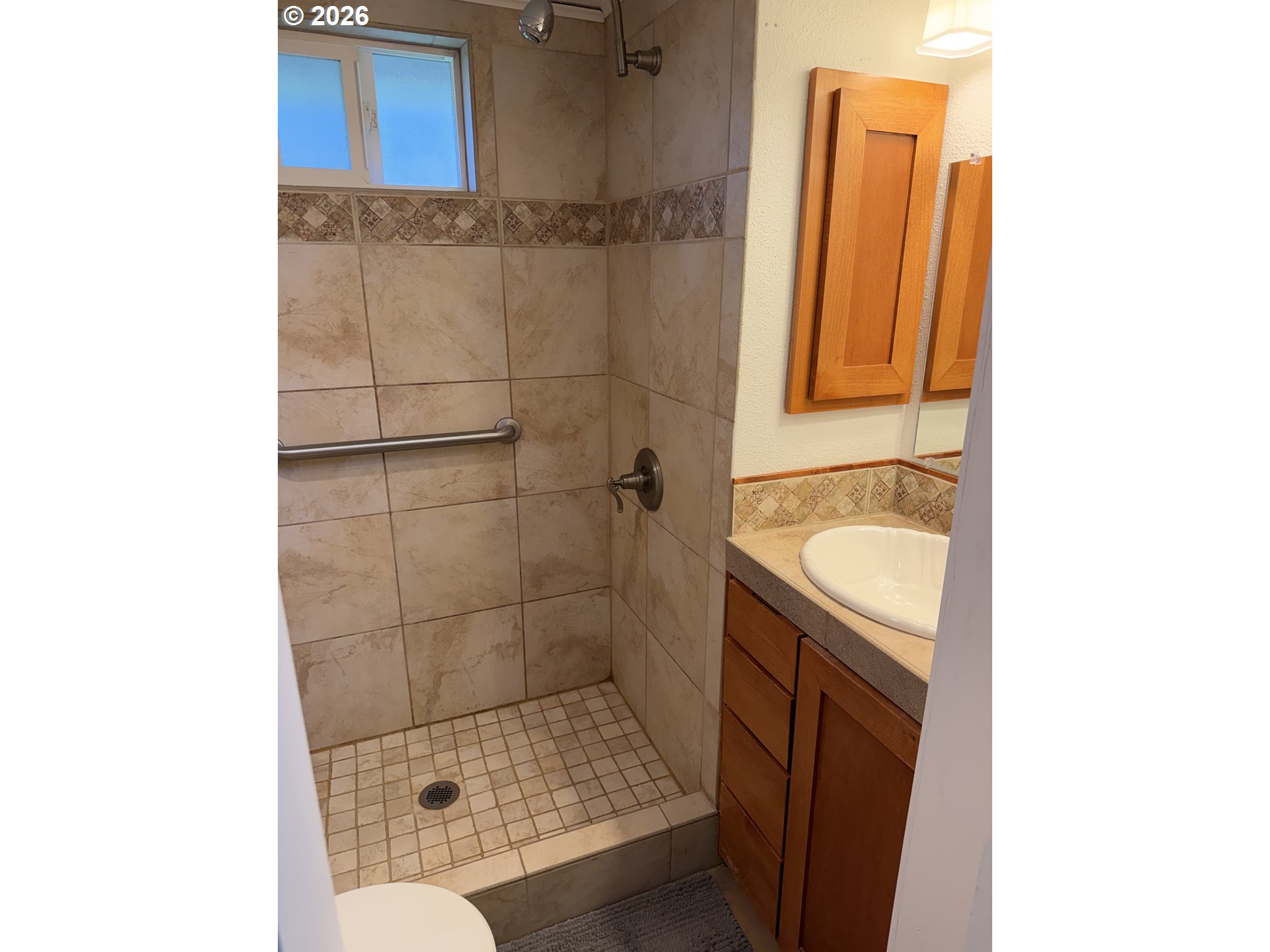 39 Easy Street Florence, OR 97439 - Photo 16 of 24 a bathroom with a granite countertop sink a mirror and shower