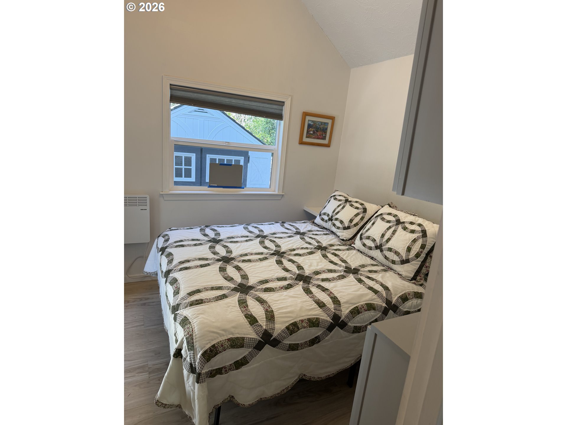 39 Easy Street Florence, OR 97439 - Photo 18 of 24 a bed sitting in a bedroom next to a bathroom sink