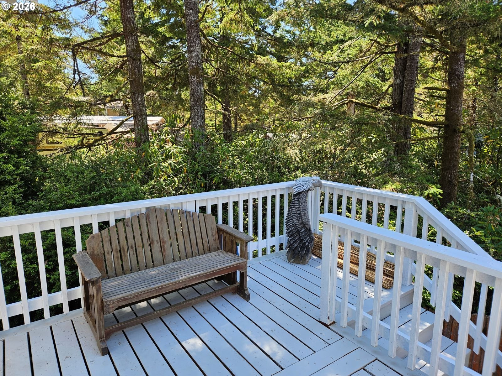 39 Easy Street Florence, OR 97439 - Photo 6 of 24 a view of a wooden deck with trees