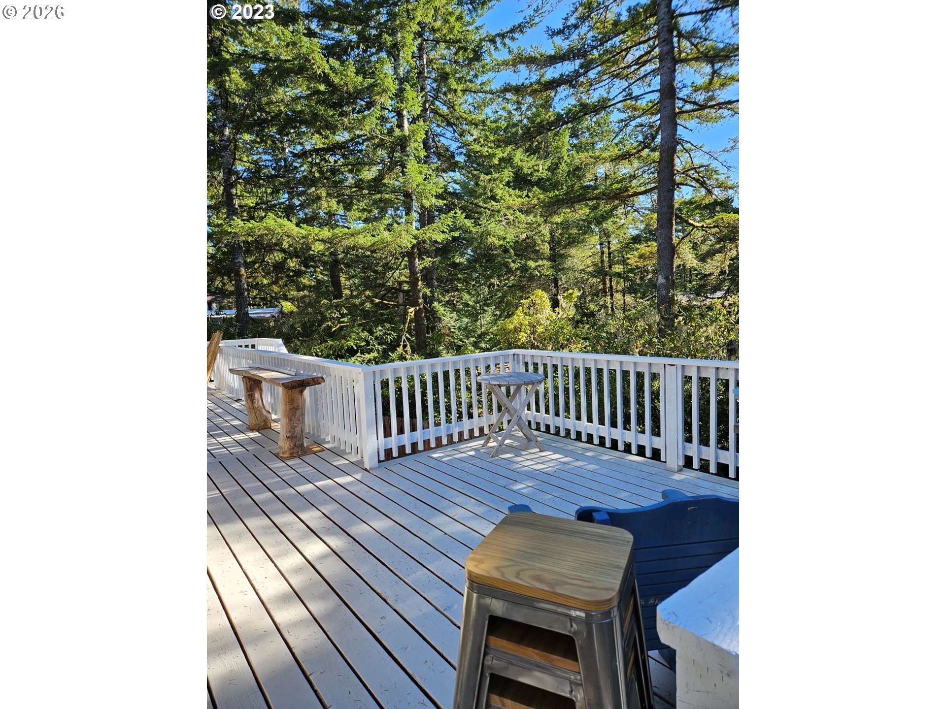 39 Easy Street Florence, OR 97439 - Photo 8 of 24 a balcony with wooden floor table and chair