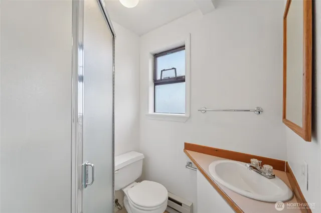 a white toilet sitting next to a bathroom sink