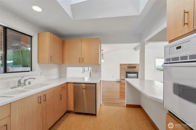 a kitchen with a sink cabinets and window