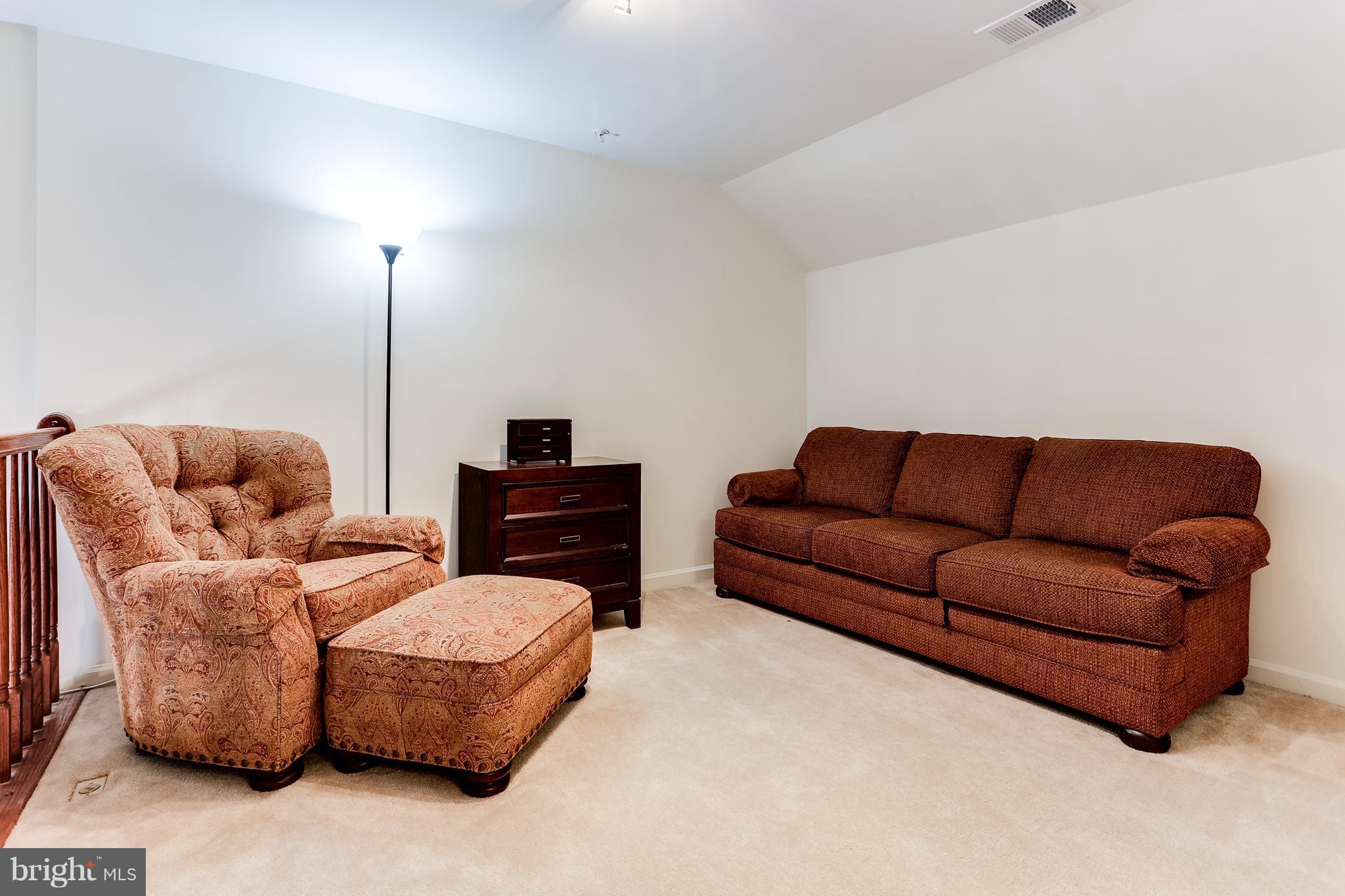 6912 Red Clay Forge, Unit 2 Elkridge, MD 21075 - Photo 12 of 30 a living room with furniture a ceiling fan and a lamp