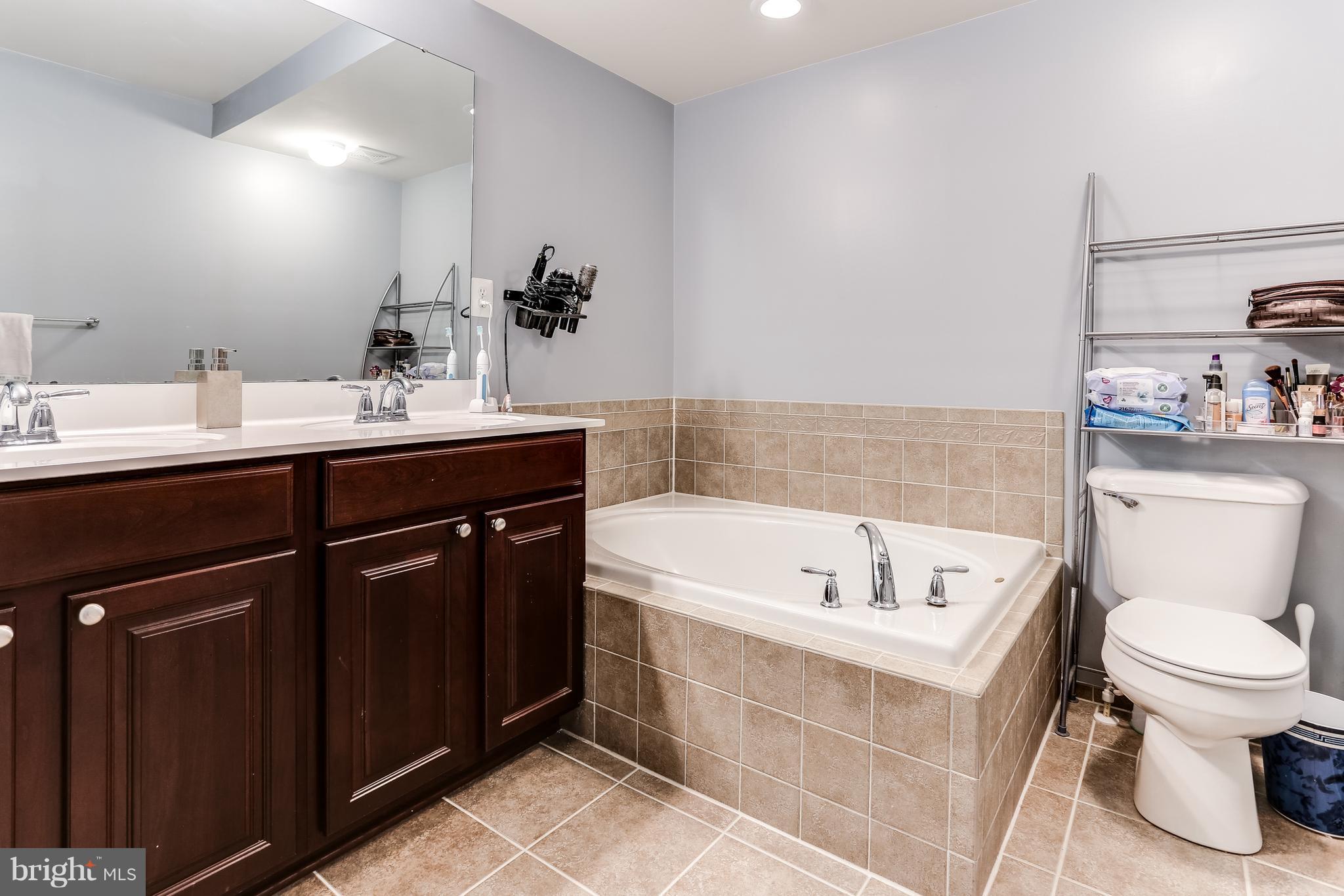6912 Red Clay Forge, Unit 2 Elkridge, MD 21075 - Photo 15 of 30 a bathroom with a sink a toilet and bathtub