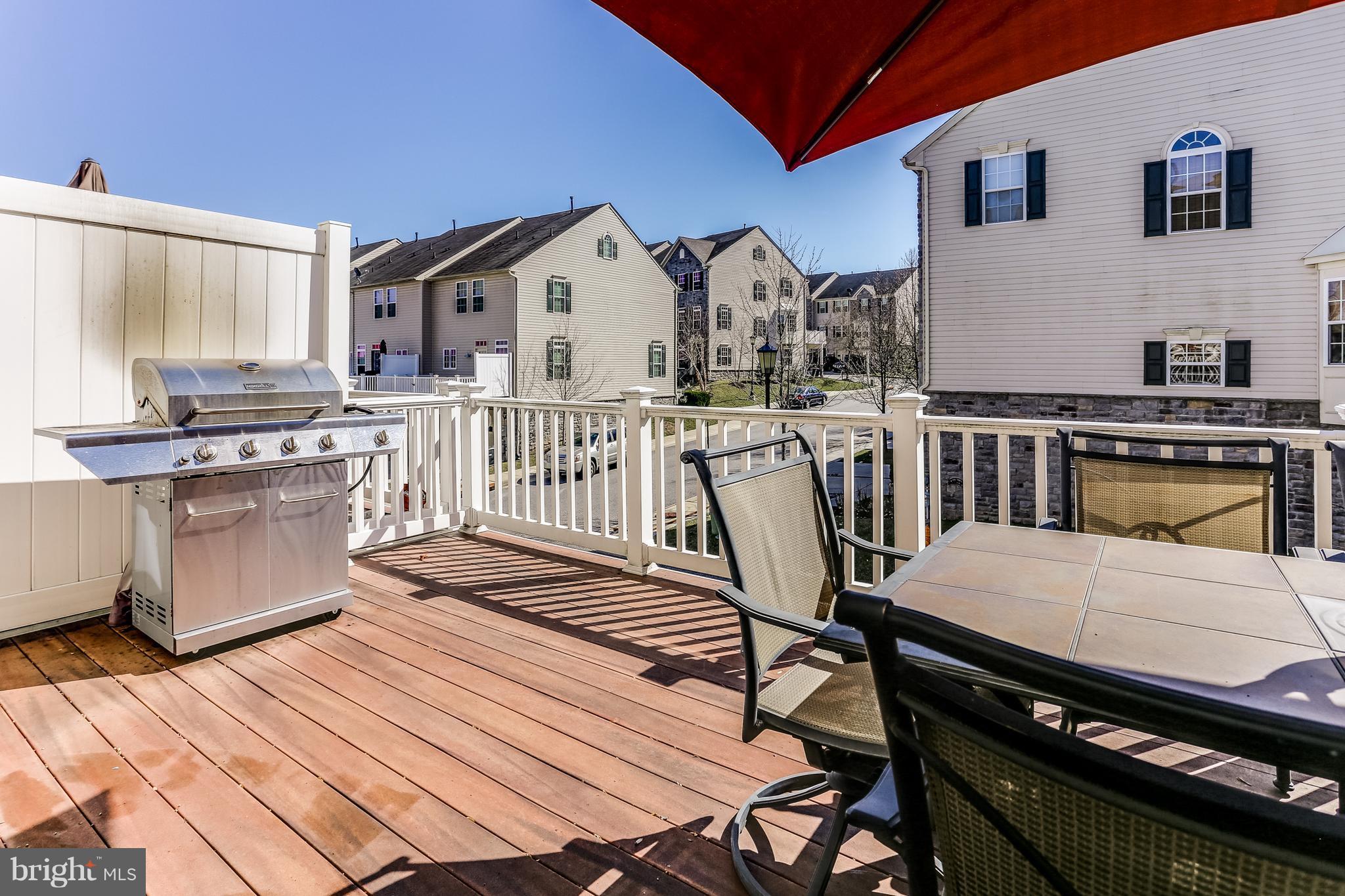 6912 Red Clay Forge, Unit 2 Elkridge, MD 21075 - Photo 19 of 30 a view of a kitchen with table chairs and wooden floor
