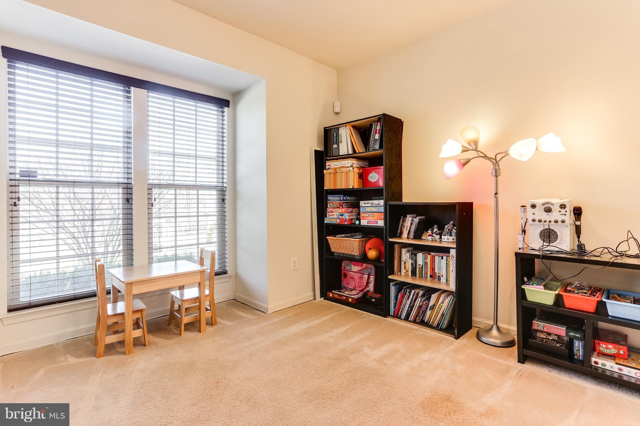 6912 Red Clay Forge, Unit 2 Elkridge, MD 21075 - Photo 3 of 30 a bedroom with furniture and a book shelf
