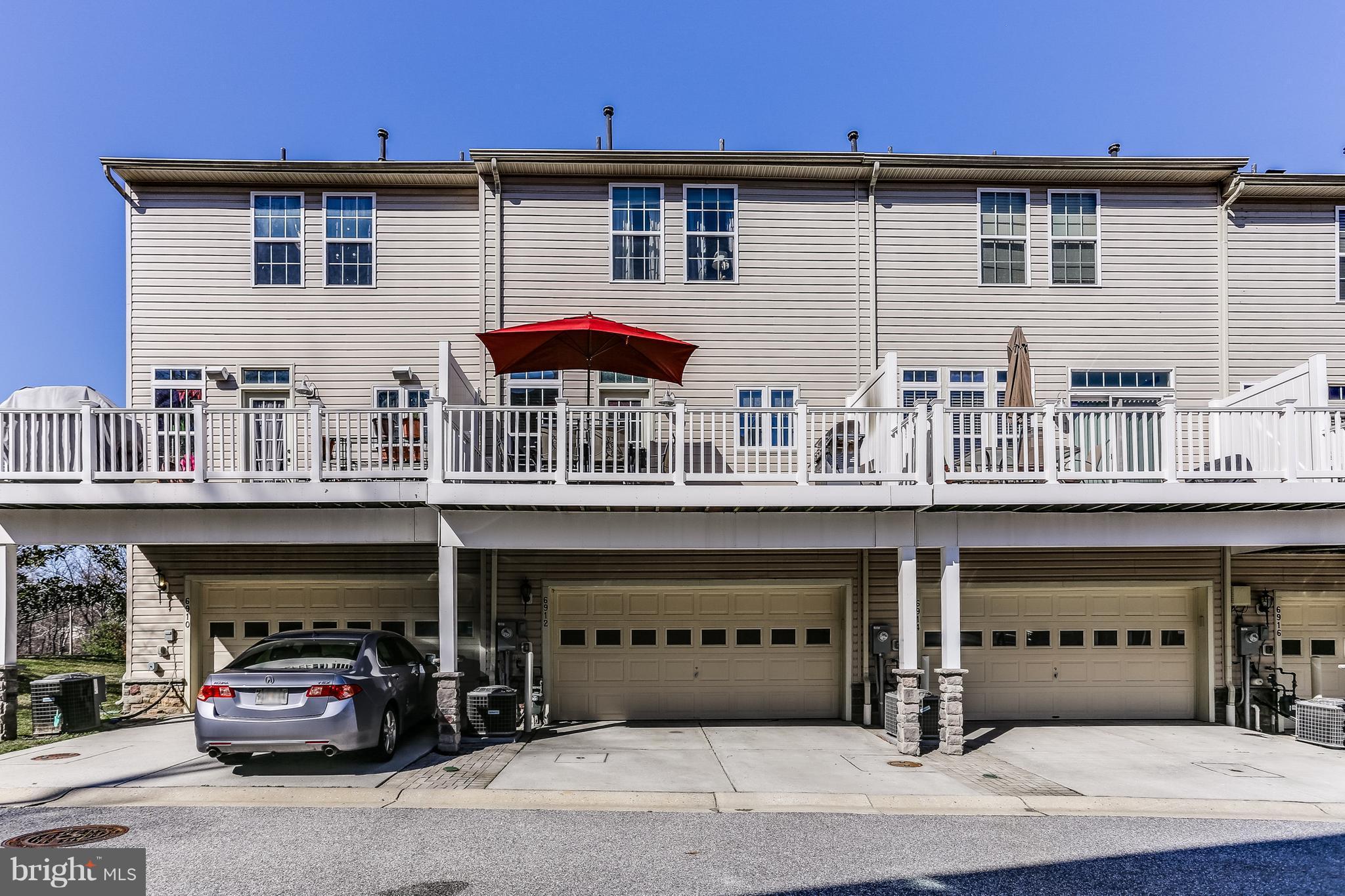 6912 Red Clay Forge, Unit 2 Elkridge, MD 21075 - Photo 21 of 30 a front view of a building with car parked