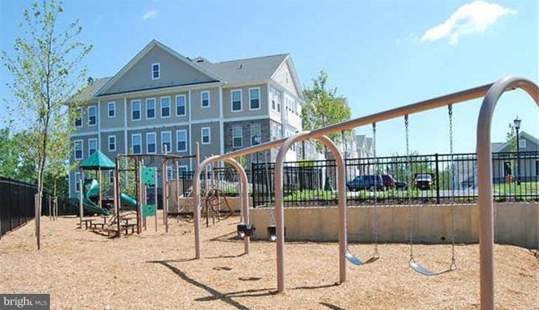 6912 Red Clay Forge, Unit 2 Elkridge, MD 21075 - Photo 24 of 30 a view of a building with a garden