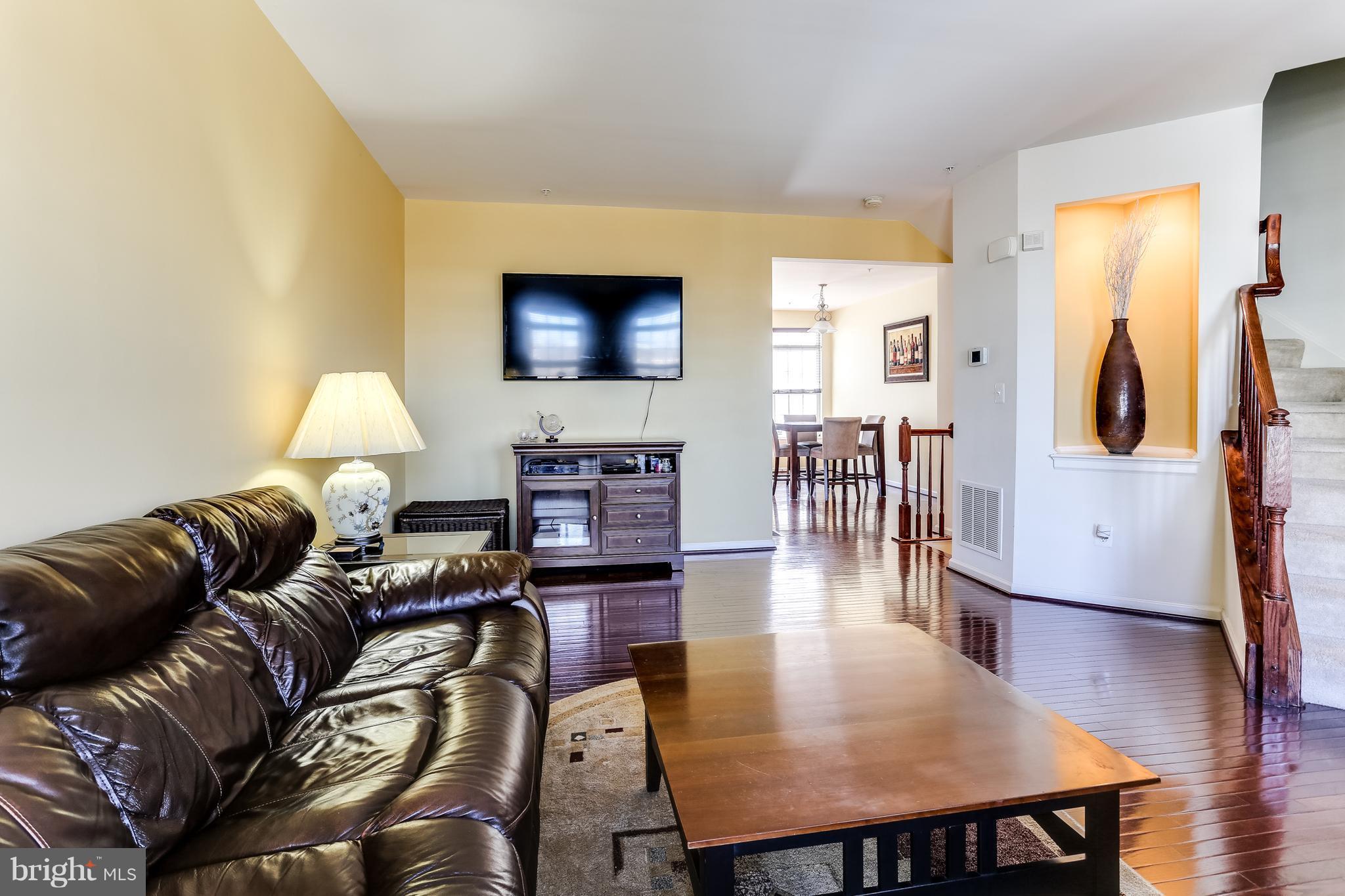 6912 Red Clay Forge, Unit 2 Elkridge, MD 21075 - Photo 4 of 30 a living room with furniture and a flat screen tv