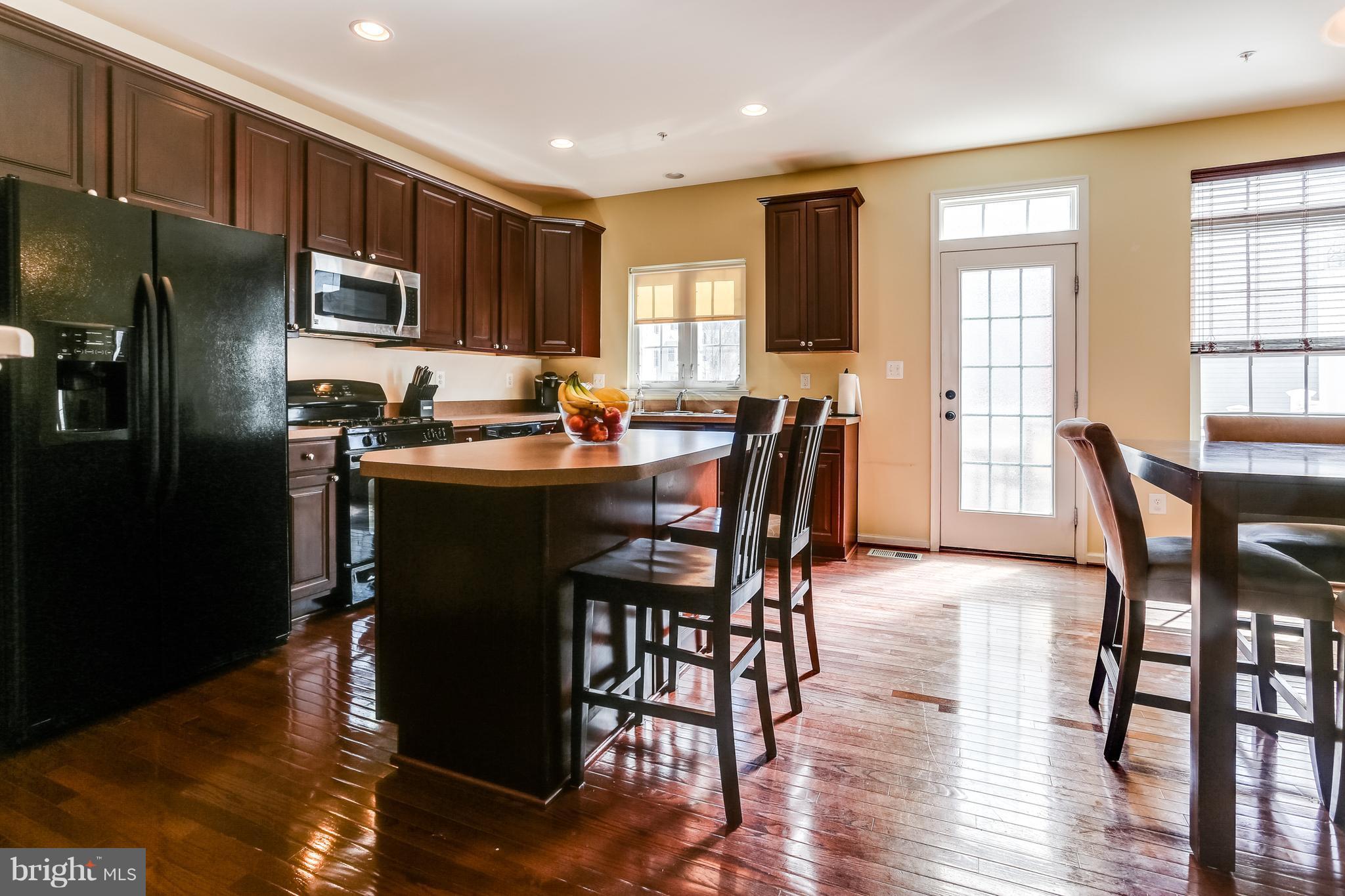 6912 Red Clay Forge, Unit 2 Elkridge, MD 21075 - Photo 6 of 30 a view of a dining room with furniture window and wooden floor
