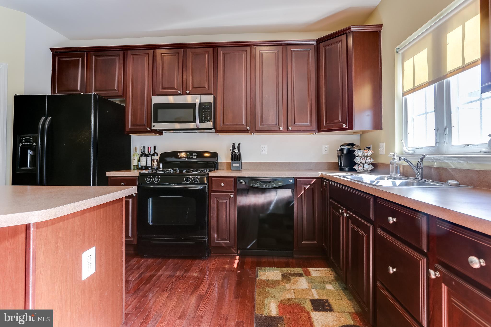 6912 Red Clay Forge, Unit 2 Elkridge, MD 21075 - Photo 7 of 30 a kitchen with a sink stove and refrigerator
