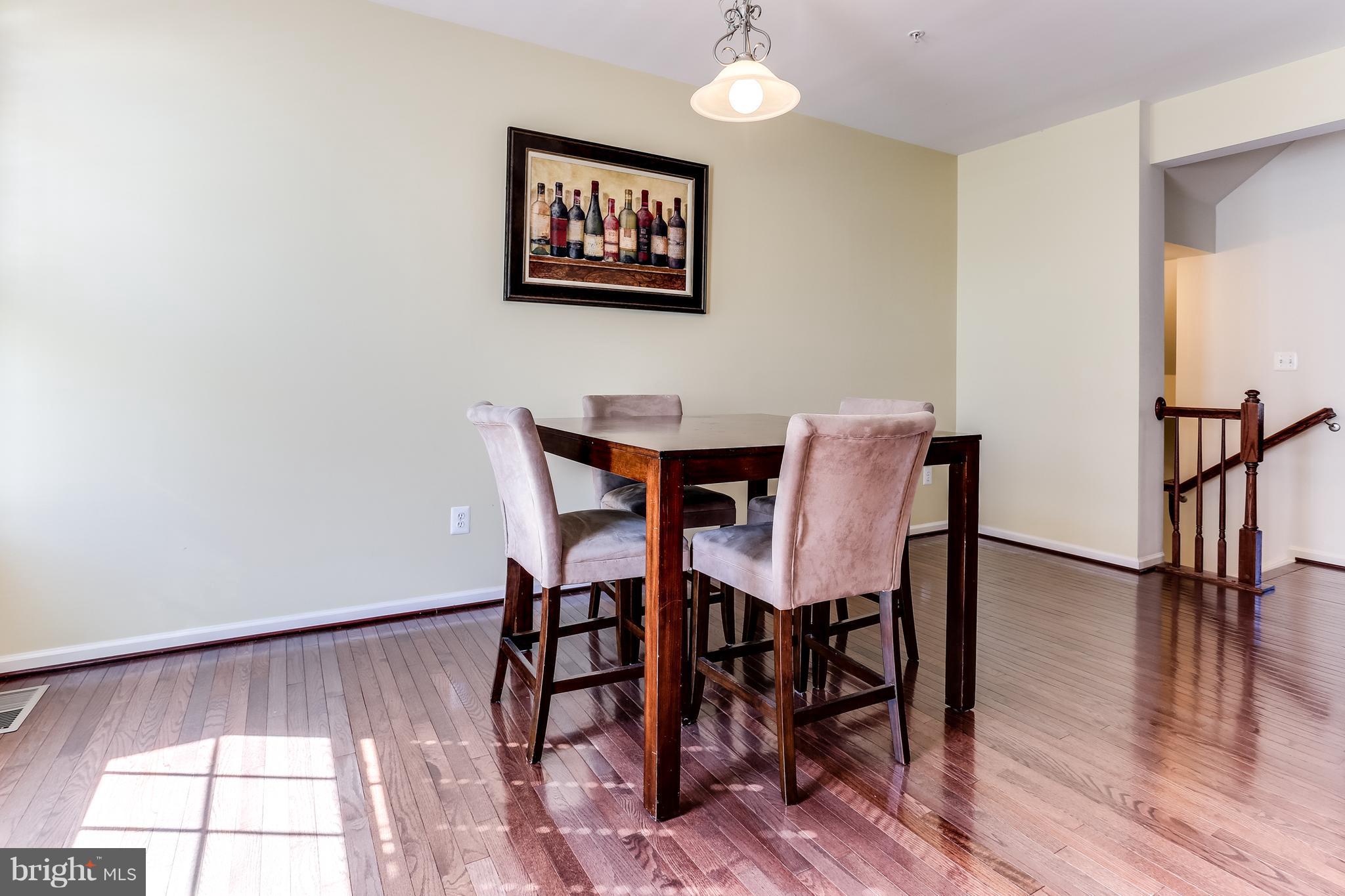 6912 Red Clay Forge, Unit 2 Elkridge, MD 21075 - Photo 9 of 30 a view of a dining room with furniture and wooden floor