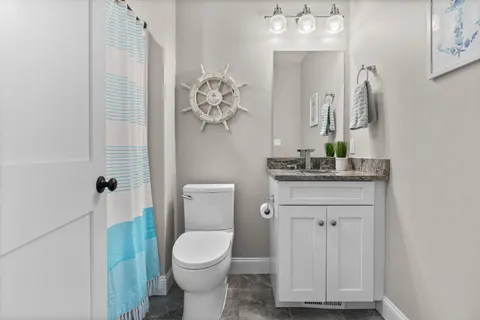 a bathroom with a toilet a sink and mirror